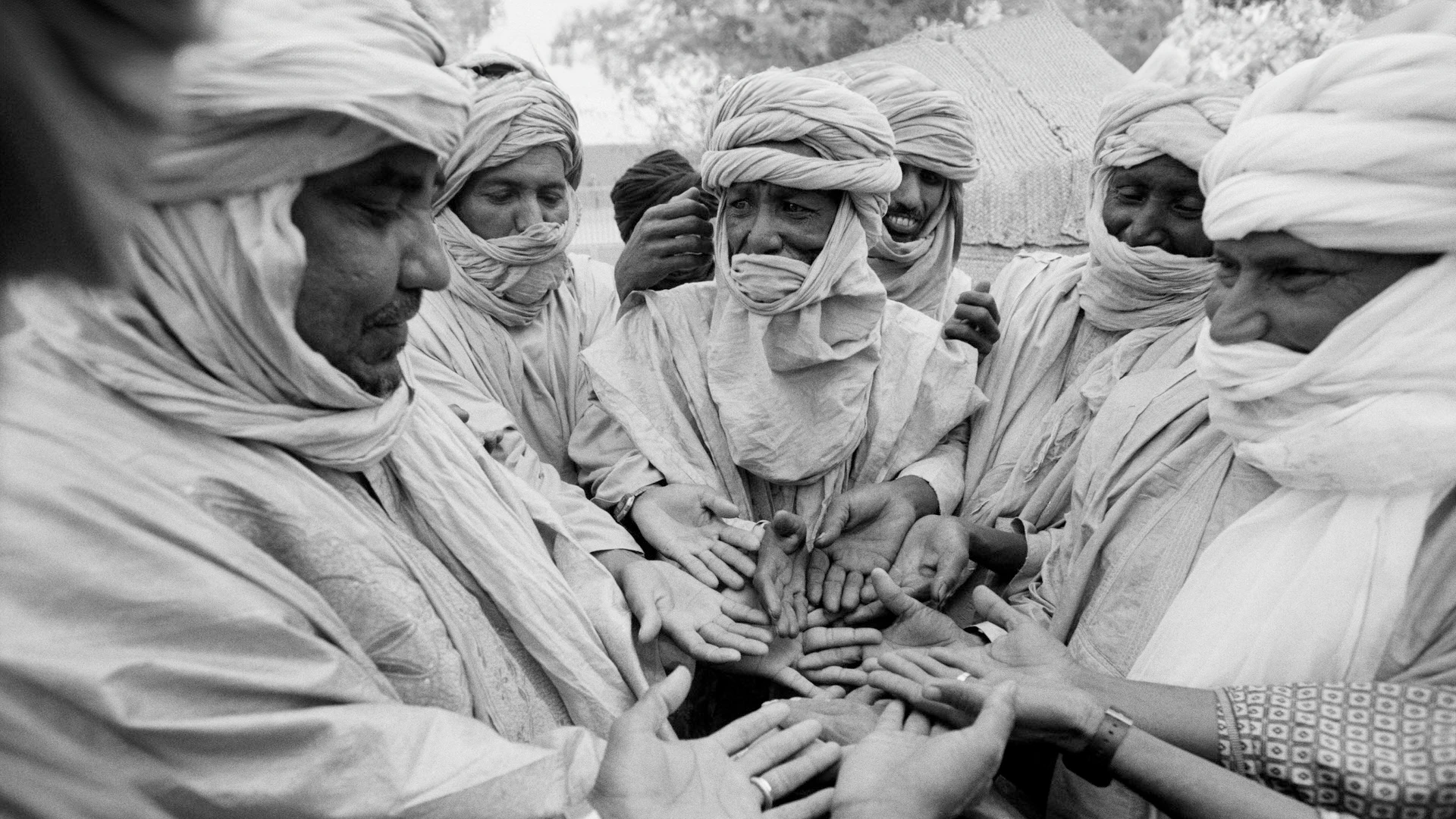 Global Peacebuilder Network - Eight men with turbans in a circle discussing with each other
