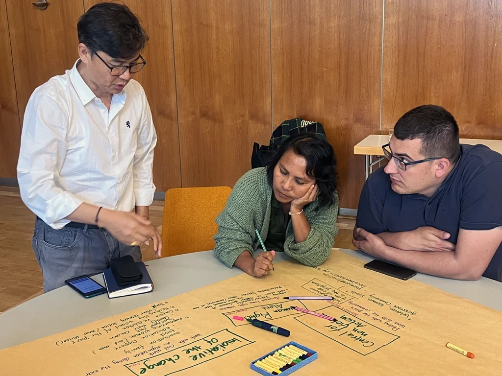 Joint emergency team - three people at a table working on a presentation